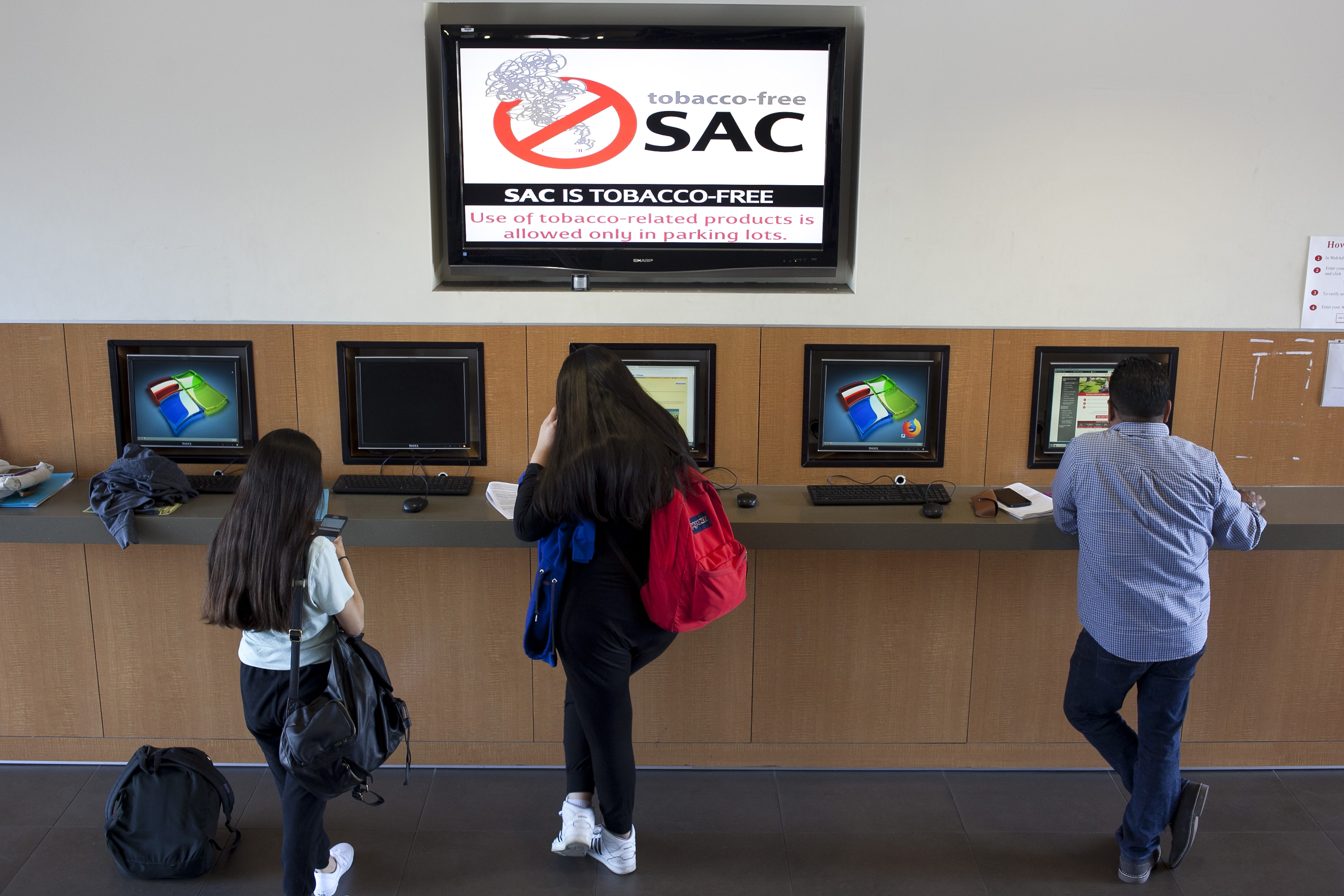 students using self service computer counter in Admissions lobby